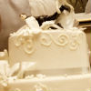 Elaborately-detailed two-tiered cake with amusing topper